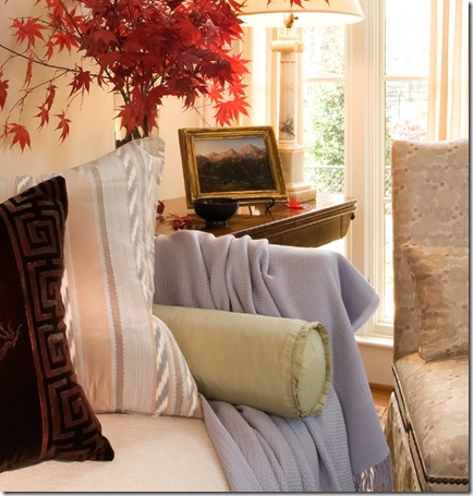 A vignette of lilacs, reds and creams in the Virginia living room of a Huntley &amp; Co. client.