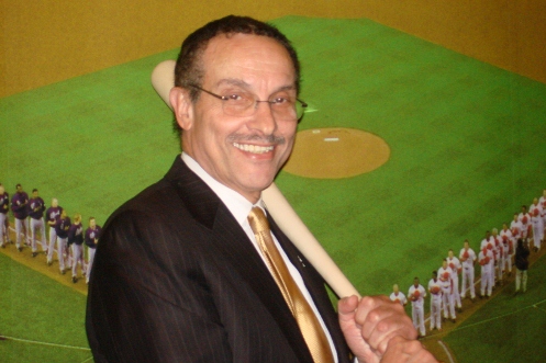 Mayor Gray with his new bat in front of a mural at the park