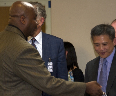 Coach Thompson (left) &amp; GU Board of Directors Chairman Paul Tagliabue discuss trip with Kin Moy