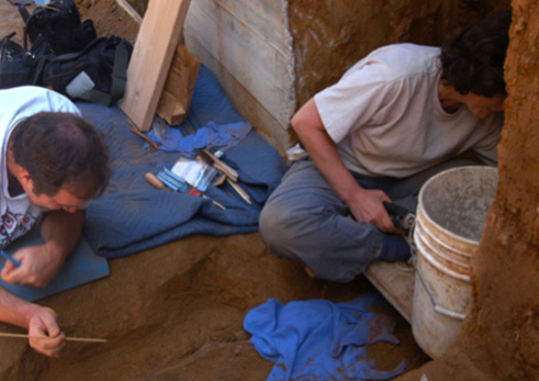 Michael McGinnes, left, and Ruth Trocolli work on excavating the Q Street burials site.