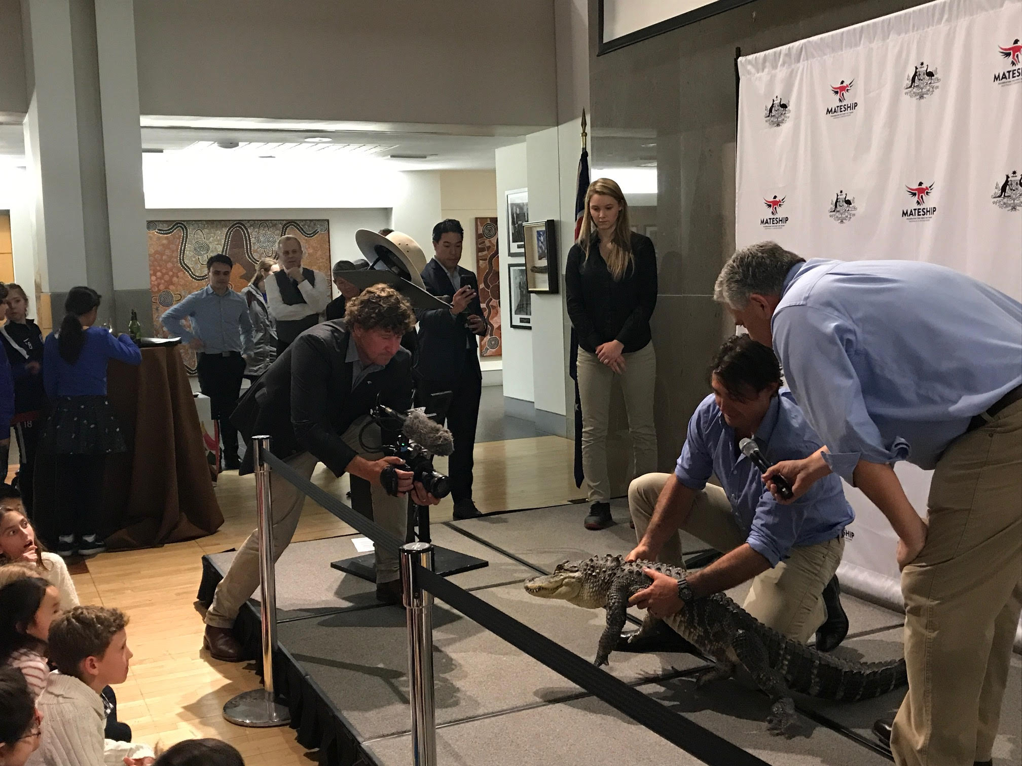 Cinematographer Ash Dunn films a croc with Monster Croc Wranglers Matt Smith and Ambassador Joe Hockey at the Australian Embassy