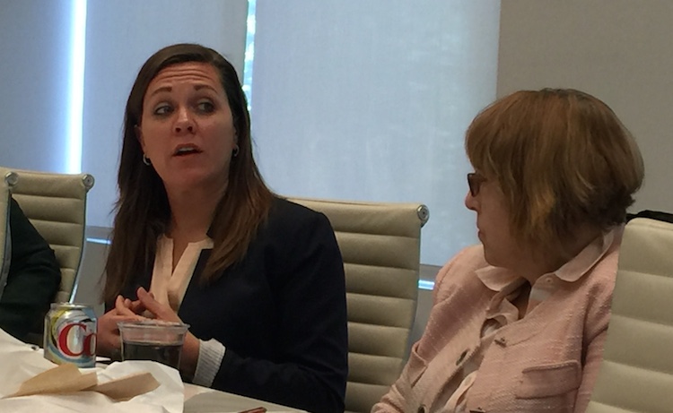 US Army Veteran Brandy Schantz speaks out as Women in Housing and Finance President-elect Martha Clarke listens