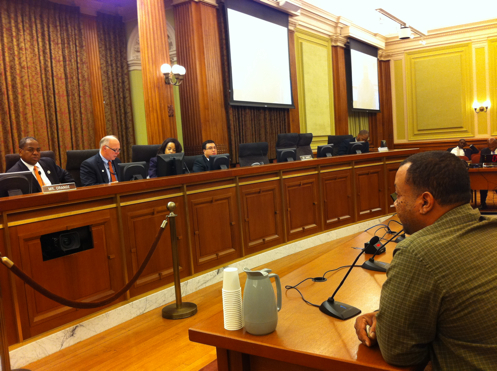 Hatmaker Anthony Gaskins testifies before a Committee hearing led by Councilmember Vincent Orange
