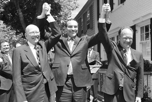 ANC chair Ron Lewis, Mayor Vincent Gray and GU president John DeGioia celebrate at a June announcement of the agreement.