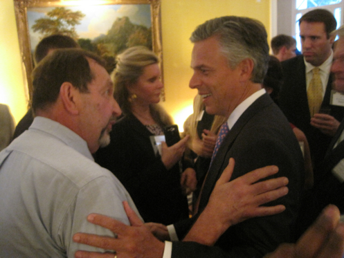 Jon Huntsman, left, speaks with D.C. activist Nelson Rimensnyder, as Georgetowner Maureen Agron, center, stands by