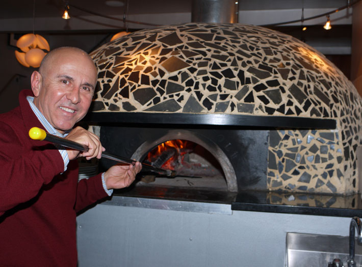 Giuseppe Joe Farruggion with his ceramic-tiled pizza oven