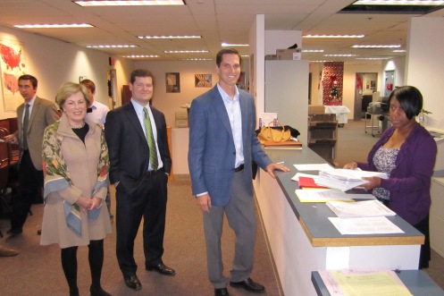 Josh Romney (in blue jacket) hands in petitions for his father, with Betsy Werronen (left) and Patrick Mara, supporters