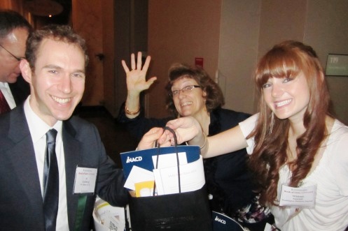 Linda Al-Jaradat (center) of the Journal waves as Al Goldberg (left) of W. Miller &amp; Co. is handed his bag by Whitney Suntum