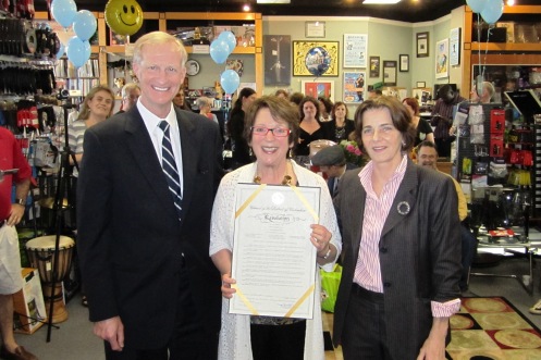 Myrna Sislen (center) with the Council resolution and Councilmembers Mary Cheh and Jack Evans