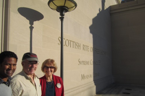 Tour volunteers Kishan Putta, Bill Elcome and Jacqueline Rose in front of the Scottish Rite Temple