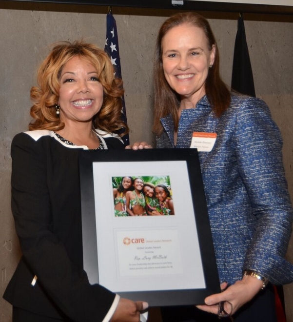Rep.-elect Lucy McBath (L) is presented with CARE Global Leaders Network award Michele Flournoy