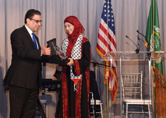 H.E. Ambassador Salah Sarhan presenting the Award to Ms. Hanan Al-Hroub