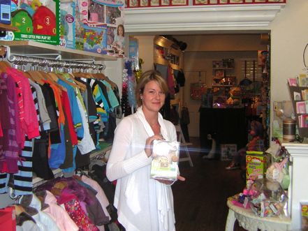 Piccolo Piggies' Carley Litchfield holds a mystery gift that will be featured in the Georgetown Gift Guide in December