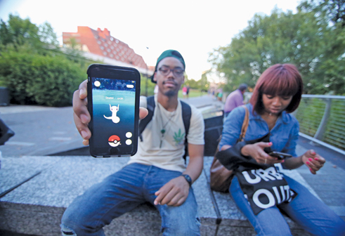 Players catch Pokémon at the Georgetown Waterfront Park on Thursday.