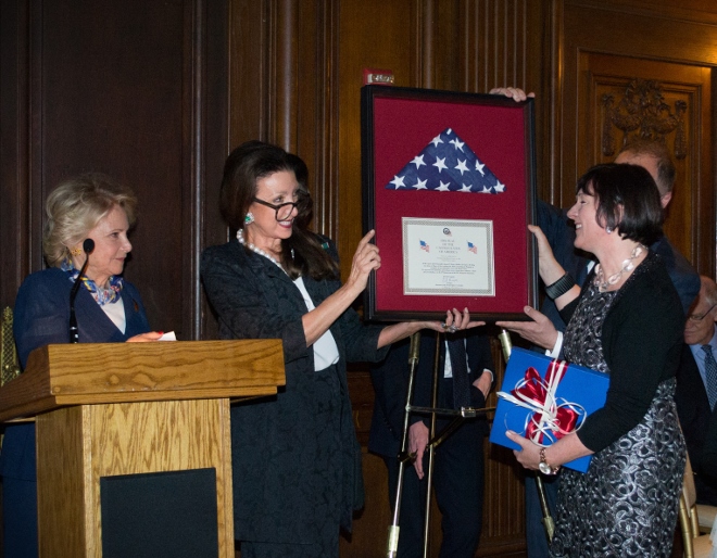 Amb. Reka Szemerkenyui (right) presented flag by Aniko Gaal Schott and  Mary Mochary