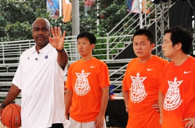 Coach John Thonpson III instructs youth in China