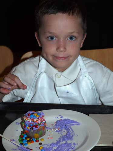 Aidan completes his three-tiered cupcake creation