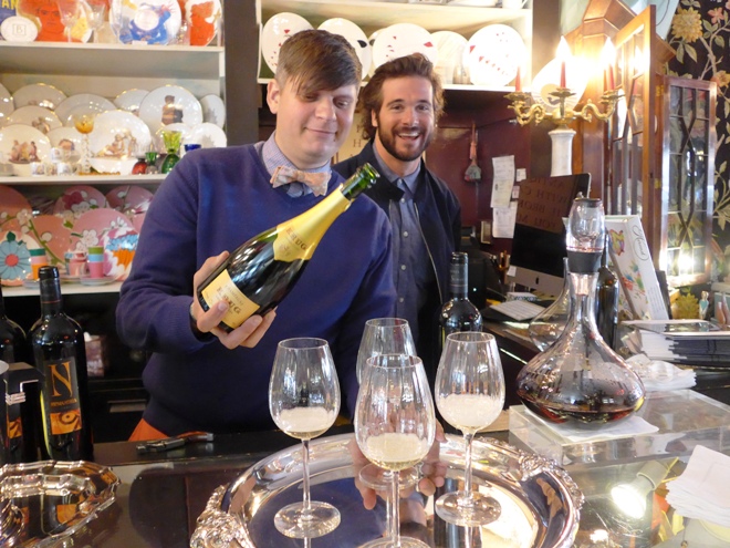 Sebastian Zutant pours champagne at Consiter It Done with help from Brendan Sinatra