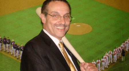 Mayor Gray with his new bat in front of a mural at the park