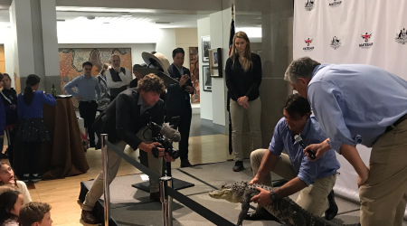 Cinematographer Ash Dunn films a croc with Monster Croc Wranglers Matt Smith and Ambassador Joe Hockey at the Australian Embassy