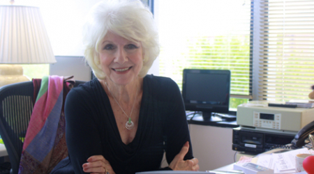 Diane Rehm, host of The Diane Rehm Show, sits at her desk