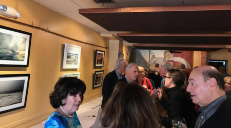 Isabel Didi Cutler surrounded by her breathtaking coastal images, friends and fans