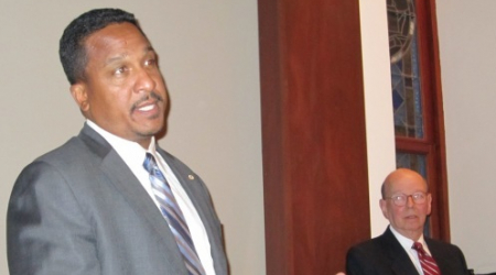 US Attorney Ronald C. Machen Jr. addresses ANC 2E, as Chair Ron Lewis looks on