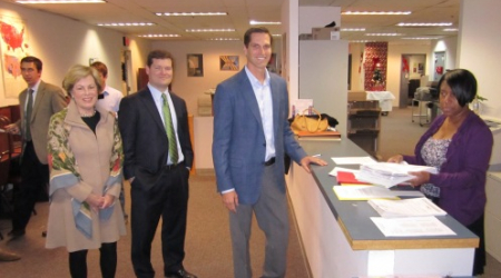 Josh Romney (in blue jacket) hands in petitions for his father, with Betsy Werronen (left) and Patrick Mara, supporters