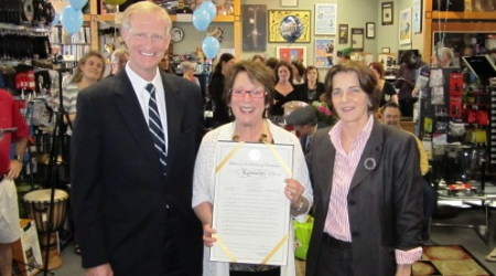 Myrna Sislen (center) with the Council resolution and Councilmembers Mary Cheh and Jack Evans