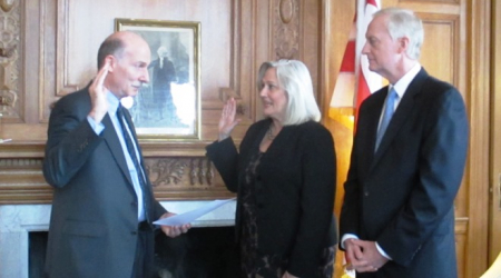 Council Chair Mendelson (left) swears-in Kathy Patteerson as DC Auditor, as Councilmember Jack Evens looks on