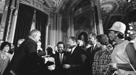 President Lyndon B. Johnson, Martin Luther King, Jr., and Clarence Mitchell Jr. at the signing of the Voting Rights Act