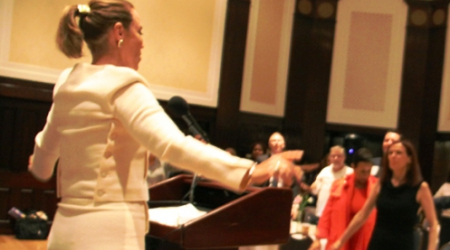 Pamela Peeke, MD and NY Times best selling author leads symposium attendees in a group stretch.