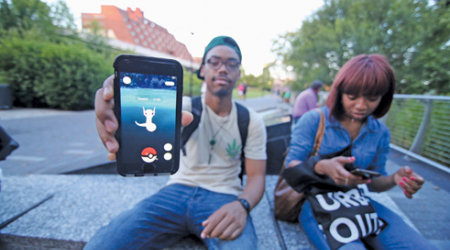 Players catch Pokémon at the Georgetown Waterfront Park on Thursday.