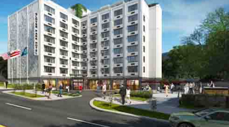 This preliminary concept rendering shows the tweaked exterior and new roof deck at the Savoy Suites Hotel.