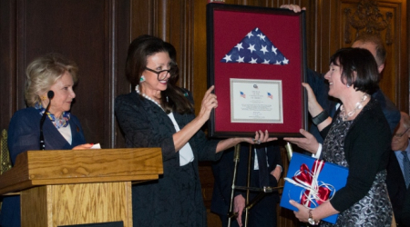 Amb. Reka Szemerkenyui (right) presented flag by Aniko Gaal Schott and  Mary Mochary