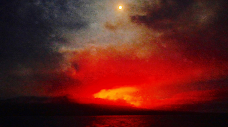 Full moon over Fernandina Island Erupting Volcano