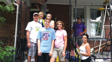 Volunteers gathered on the front porch of a Columbia Heights home, where they worked on various home improvement projects.